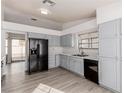 Modern kitchen with gray cabinets and black appliances at 6200 Budnick Cir, Las Vegas, NV 89130