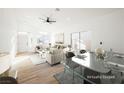 Open concept dining area with contemporary glass table and seating at 6304 Tanzanite Ave, Las Vegas, NV 89130