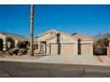 Tan two-car garage home with desert landscaping at 6304 Tanzanite Ave, Las Vegas, NV 89130