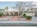 House exterior with mature tree, walkway, and two-car garage at 6513 Hyde Ave, Las Vegas, NV 89107