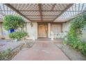 Covered front porch with decorative latticework and a walkway at 6513 Hyde Ave, Las Vegas, NV 89107