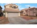 View of two-story home with beige exterior, tile roof, and concrete driveway at 6712 Painted Canyon Ct, Las Vegas, NV 89130