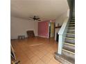 Living room with tile floors, fireplace, and staircase at 7090 Burcot Ave # B32, Las Vegas, NV 89156