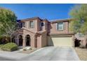 Two story house with beige exterior, attached garage, and landscaping at 7182 Hood River Ave, Las Vegas, NV 89179