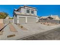 Two-story house with three-car garage and side driveway at 7900 Holly Knoll Ave, Las Vegas, NV 89129