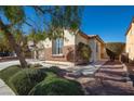 Front yard walkway leads to a charming house with side yard landscaping at 968 Mill Run Creek Ave, Henderson, NV 89002