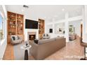 Spacious living area with built-in bookshelves, cozy fireplace, and bright, open layout; virtually staged at 10920 Grand Haven Ave, Las Vegas, NV 89134