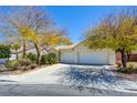Beautiful home with a three-car garage, mature trees, and well-maintained landscaping at 1140 Woodcastle St, Henderson, NV 89052