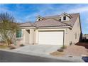 House exterior with two-car garage and desert landscaping at 1348 Mariposa Way, Mesquite, NV 89027