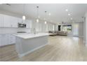 Modern kitchen with white cabinets, large island, and stainless steel appliances at 1348 Mariposa Way, Mesquite, NV 89027
