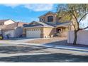 Two-story house with a two-car garage and landscaped yard at 1736 Hill Canyon Ln, Las Vegas, NV 89144