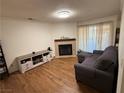 Living room with corner fireplace, wood-look floors and patio access at 2200 S Fort Apache Rd # 1207, Las Vegas, NV 89117