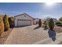 Attractive single-story home with a large driveway and a well manicured front yard and desert landscaping at 2204 Twin Falls Dr, Henderson, NV 89044