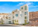 Contemporary desert home with a yellow door and hillside view at 394 Solitude Peak Ln, Henderson, NV 89012
