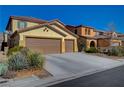 Two-story house with three-car garage and desert landscaping at 4412 Meadowbloom Ave, North Las Vegas, NV 89085