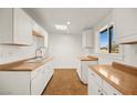 Bright kitchen featuring white cabinets and laminate countertops at 4520 Harmon Cir, Las Vegas, NV 89122