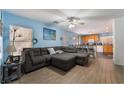 Open living room and kitchen with L-shaped sofa and breakfast bar at 585 Dairy Creek Ave, Las Vegas, NV 89183