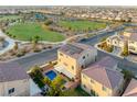 Aerial view of a home with solar panels and a private backyard pool in a community near a park at 6595 Creekside Cellars Ct, Las Vegas, NV 89139