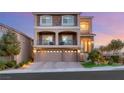 Well-maintained two-story home featuring stone accents, a three-car garage, and manicured landscaping at 6595 Creekside Cellars Ct, Las Vegas, NV 89139