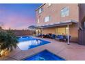 Backyard featuring a sparkling pool, hot tub, covered patio, and ample seating area at 6595 Creekside Cellars Ct, Las Vegas, NV 89139