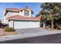 Two-story house with a three-car garage and desert landscaping at 7628 Tortola Bay Ln, Las Vegas, NV 89128