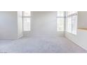 Bright living room with large windows and carpet flooring at 7628 Tortola Bay Ln, Las Vegas, NV 89128