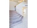 Elegant staircase with carpet runner and tiled flooring at 7628 Tortola Bay Ln, Las Vegas, NV 89128