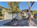 One-story home with a grey garage door and desert landscaping at 8904 Martin Downs Pl, Las Vegas, NV 89131