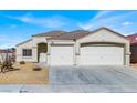 Two-car garage and front yard view of a single-story house at 1006 Christopher View Ave, North Las Vegas, NV 89032