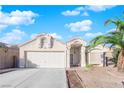 Single-story house with attached garage and desert landscaping at 1320 Indian Hedge Dr, North Las Vegas, NV 89032