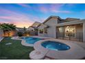 Relaxing backyard oasis featuring a pool and spa, surrounded by lush landscaping at 2465 Sturrock Dr, Henderson, NV 89044