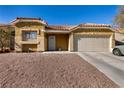 Front view of a single-story house with a neutral color scheme and desert landscaping at 2535 River Oaks Dr, Las Vegas, NV 89156