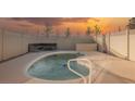 Kidney-shaped swimming pool with a white fence and fire pit at 2670 Zephyr Ave, Pahrump, NV 89048