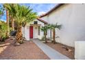 Landscaped front yard with red door entry and walkway at 2674 Alwoodley Cir, Las Vegas, NV 89142