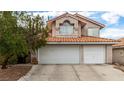 Two-story house with three-car garage and Spanish tile roof at 2849 Huber Heights Dr, Las Vegas, NV 89128