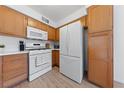 White appliances and light wood cabinets in this kitchen at 3425 E Russell Rd # 121, Las Vegas, NV 89120