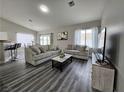 Bright living room features plush sofas, a coffee table, and wood-look floors at 3538 Canter Dr, North Las Vegas, NV 89032