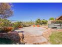 Landscaped backyard featuring a spacious patio and a relaxing hot tub for outdoor enjoyment at 36 Hunt Valley Trl, Henderson, NV 89052