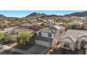 Overhead view of a lovely two-story home with a tile roof in a well-maintained neighborhood near mountains at 41 Voltaire Ave, Henderson, NV 89002