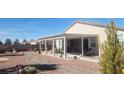 Relaxing backyard patio with pergola, seating area, and desert landscaping at 4641 Sommerset Ct, Pahrump, NV 89061