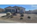 Charming house with gray two-car garage and nicely landscaped front yard at 4641 Sommerset Ct, Pahrump, NV 89061