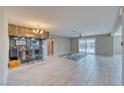 Open-concept living area with a stylish wet bar and sliding doors that leads to the backyard at 4641 Sommerset Ct, Pahrump, NV 89061