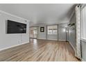 Spacious living room featuring hardwood floors and a large TV at 513 Chandler St, Henderson, NV 89014