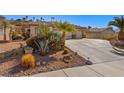 Landscaped front yard with drought-tolerant plants and a long driveway at 526 Highland View Ct, Mesquite, NV 89027