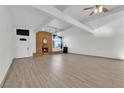 Spacious living room with brick fireplace and wood-look floors at 6205 Hargrove Ave, Las Vegas, NV 89107