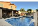 Relaxing pool with patio furniture and adjacent house at 651 Penshaw Bridge Ave, Las Vegas, NV 89178