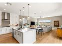 Open concept kitchen with white cabinets and large island at 8606 Dusty Quail Dr, Las Vegas, NV 89148