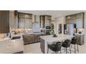 Modern kitchen with gray cabinets, quartz countertops, and large island at 9280 Copernicus Ave, Las Vegas, NV 89143