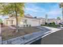 Single-story house with a two-car garage and nicely landscaped front yard at 9741 Horizon Hills Dr, Las Vegas, NV 89117