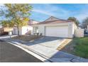 Single-story house with a two-car garage and neatly landscaped front yard at 9741 Horizon Hills Dr, Las Vegas, NV 89117